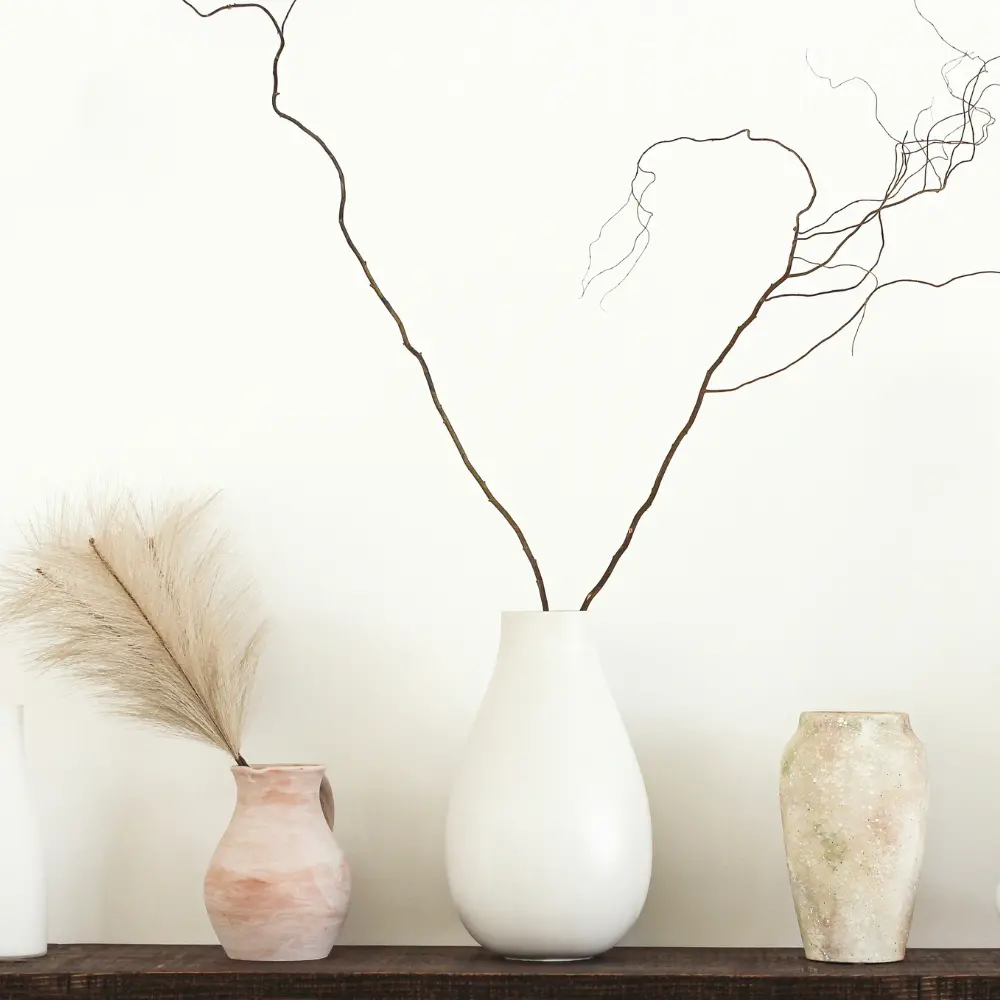 3 different vases on a shelf