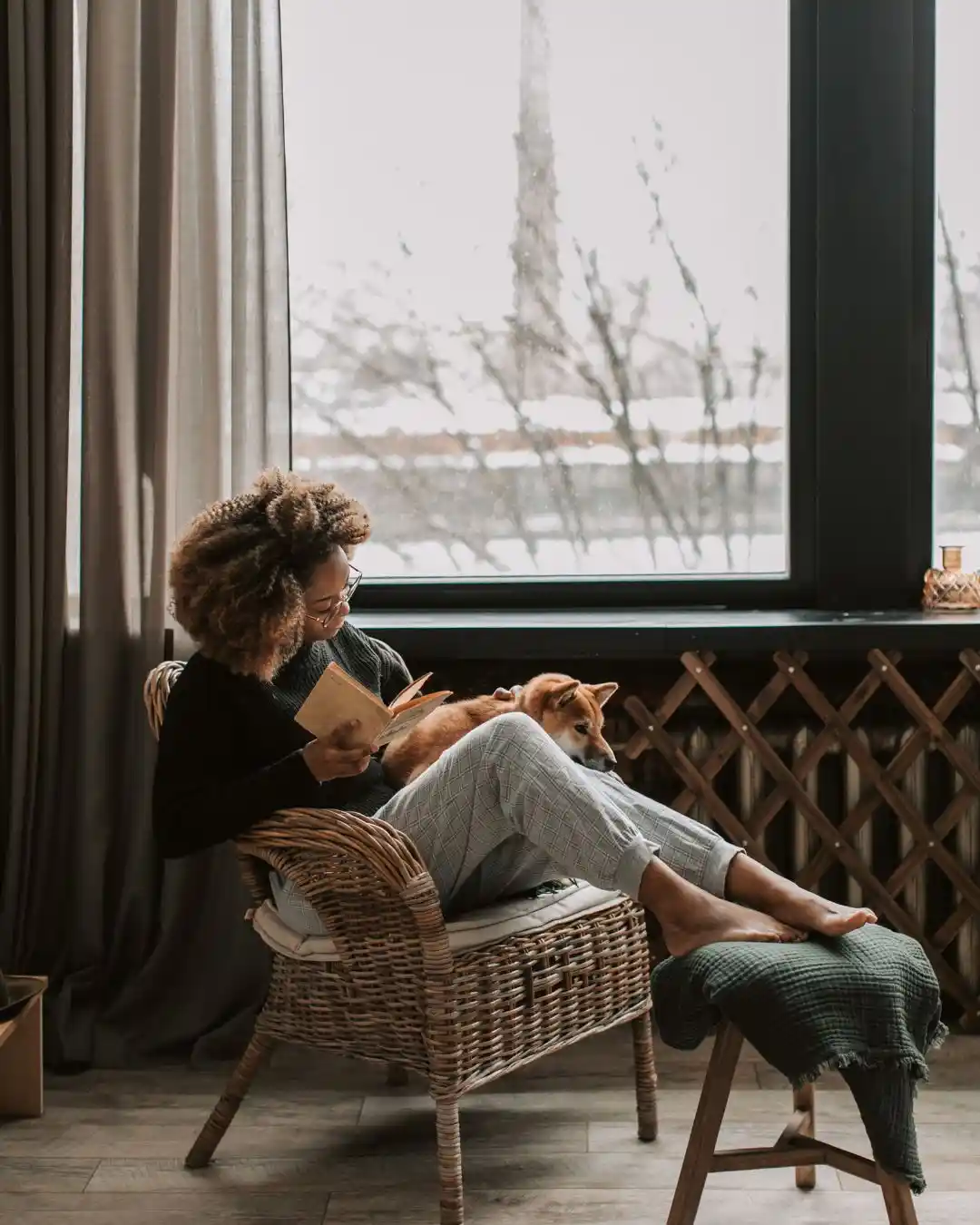 lady reading a book on a rattan chair in a cozy window reading nook 